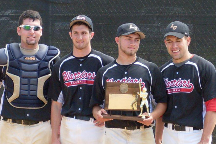 Baseball players holding a trophy