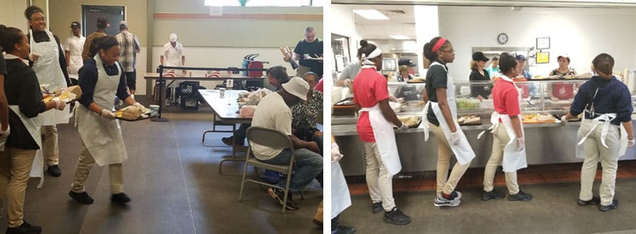 Students walking out food in the soup kitchen